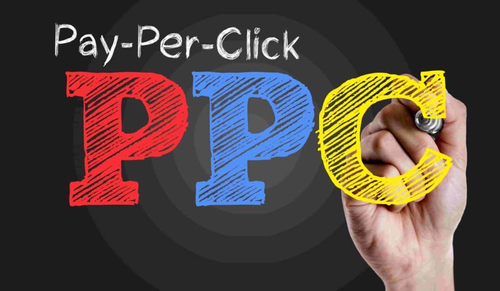 Illustration of the text 'Pay Per Click (PPC)' emphasizing pay-per-click marketing, with a hand touching the letter 'C' to symbolize interaction and engagement.
